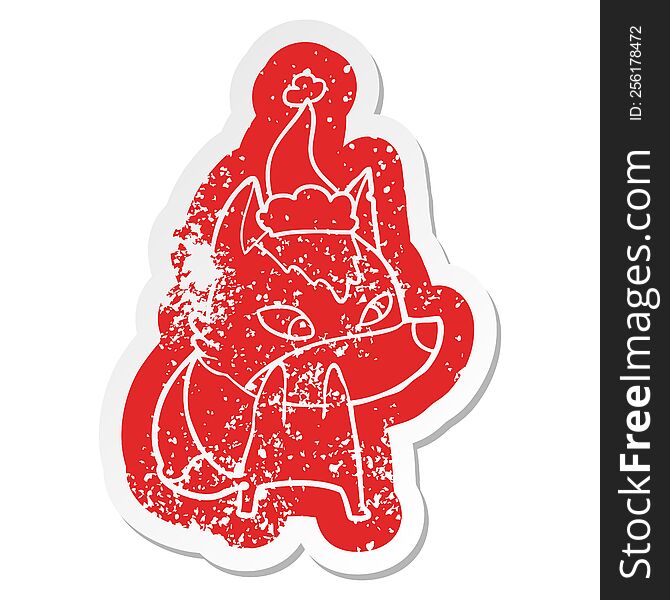 Shy Cartoon Distressed Sticker Of A Wolf Wearing Santa Hat