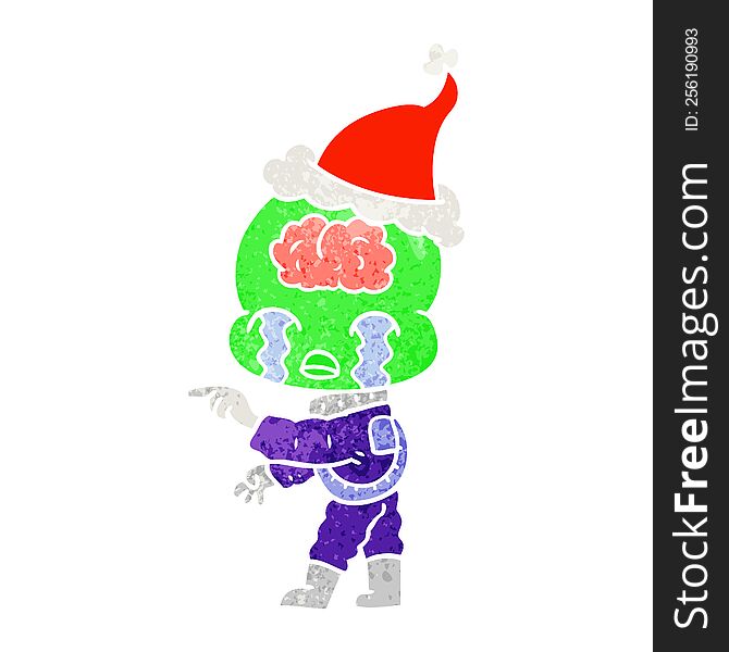 Retro Cartoon Of A Big Brain Alien Crying And Pointing Wearing Santa Hat