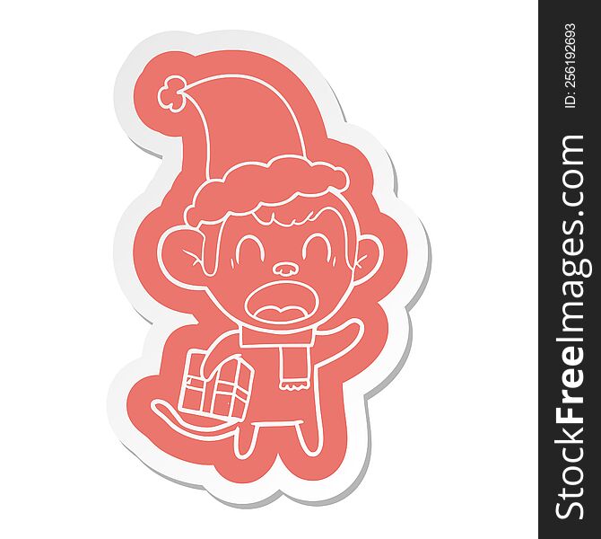 shouting quirky cartoon  sticker of a monkey carrying christmas gift wearing santa hat