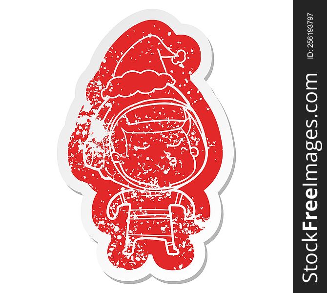 quirky cartoon distressed sticker of a confident astronaut wearing santa hat
