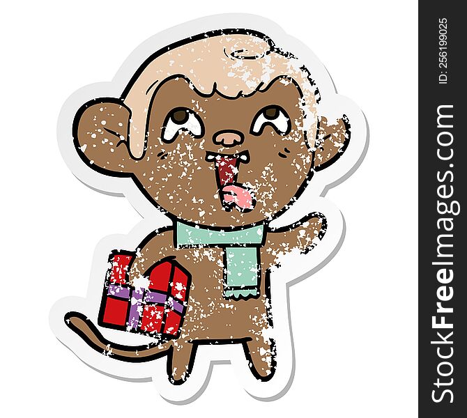 Distressed Sticker Of A Crazy Cartoon Monkey With Christmas Present
