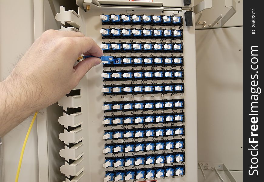 Optical fiber patch panel with a human hand