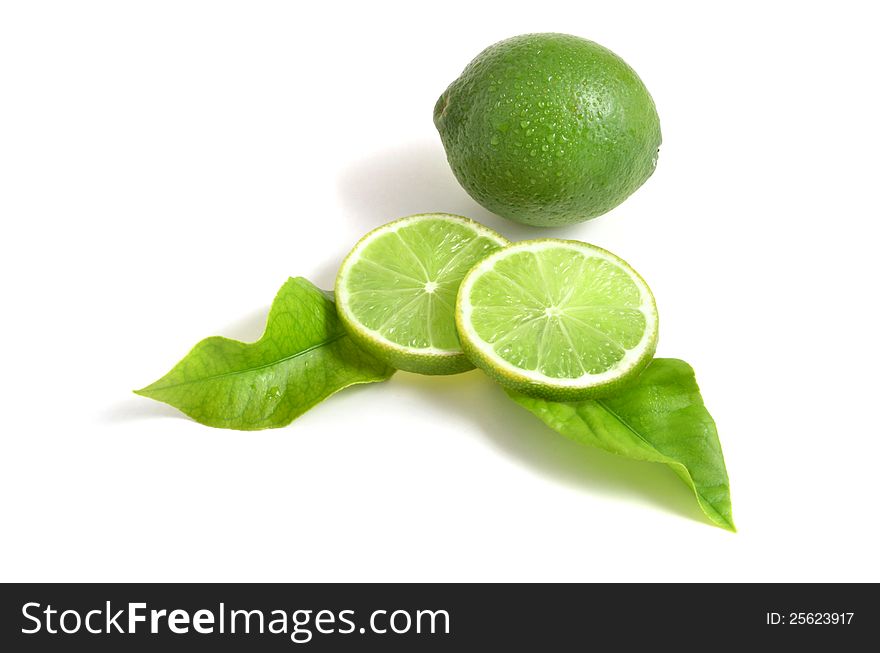 Fresh limes on white background, with leaves