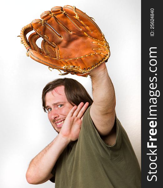 Ball is comming at the guy and he is afraid of it. Has baseball glove up as well as his arm to stop it from hitting his face.Focus is fairly shallow and on the glove though man behind still is enough focus to be usefull. Image isolated against a white background. Ball is comming at the guy and he is afraid of it. Has baseball glove up as well as his arm to stop it from hitting his face.Focus is fairly shallow and on the glove though man behind still is enough focus to be usefull. Image isolated against a white background