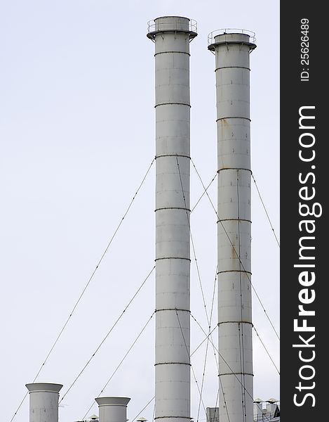 Group of old smokestacks under overcast