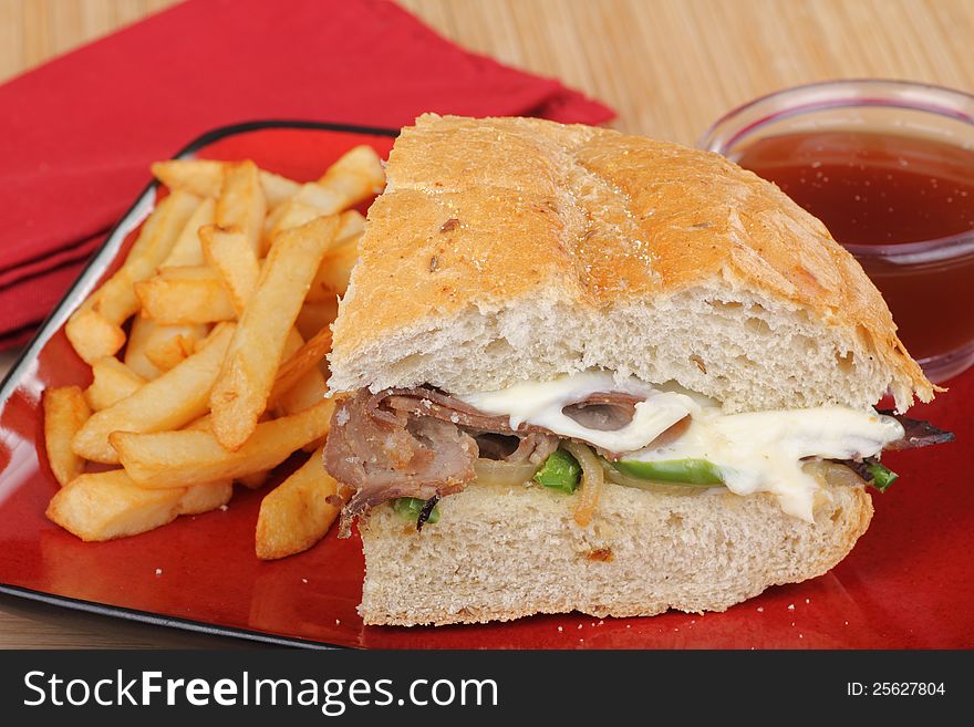Roast beef and cheese sandwich with french fries. Roast beef and cheese sandwich with french fries