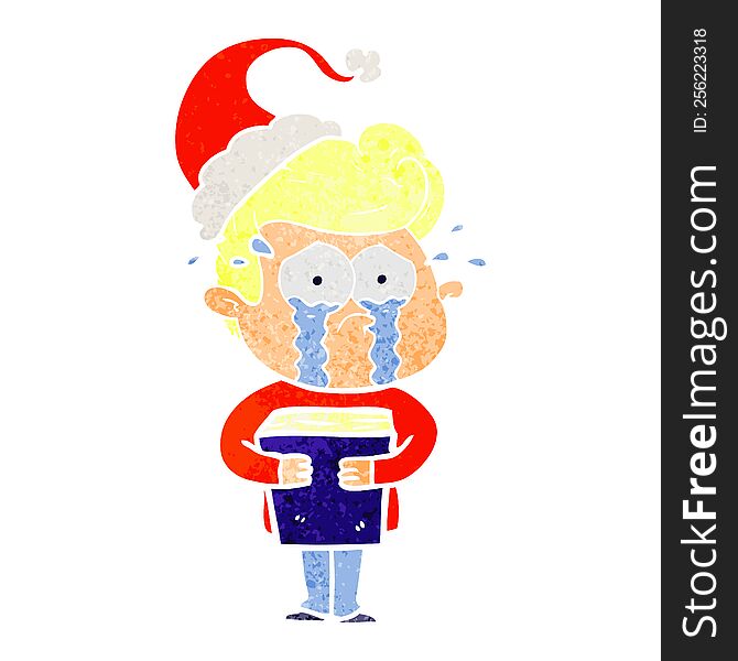 hand drawn retro cartoon of a crying man holding book wearing santa hat