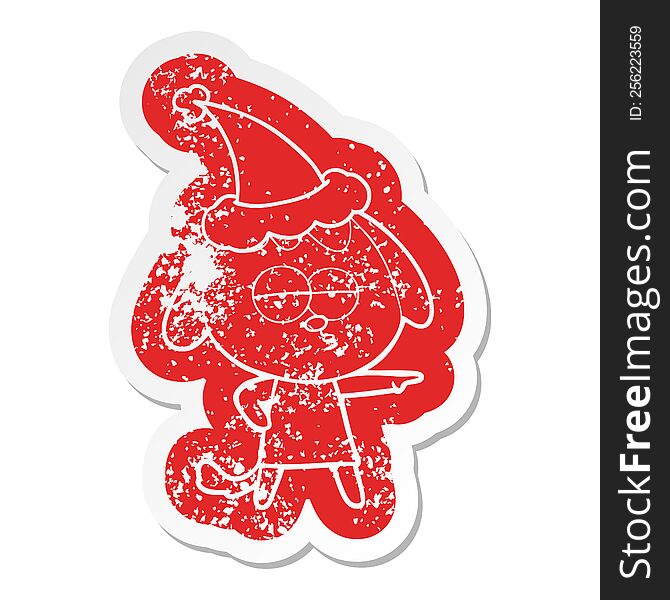 Cartoon Distressed Sticker Of A Bored Dog Wearing Santa Hat
