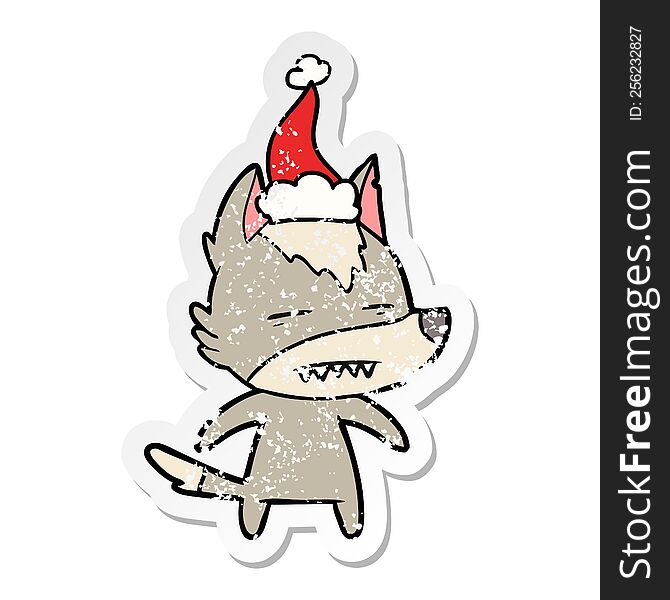 Distressed Sticker Cartoon Of A Wolf Showing Teeth Wearing Santa Hat