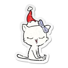 Distressed Sticker Cartoon Of A Cat With Bow On Head Wearing Santa Hat Stock Photo Distressed Sticker Cartoon Of A Cat With Bow On Head Wearing Santa Hat Stock Photo