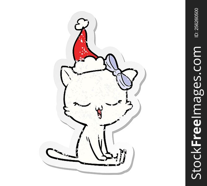 Distressed Sticker Cartoon Of A Cat With Bow On Head Wearing Santa Hat