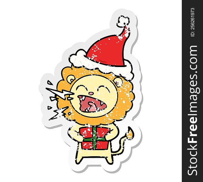 hand drawn distressed sticker cartoon of a roaring lion with gift wearing santa hat