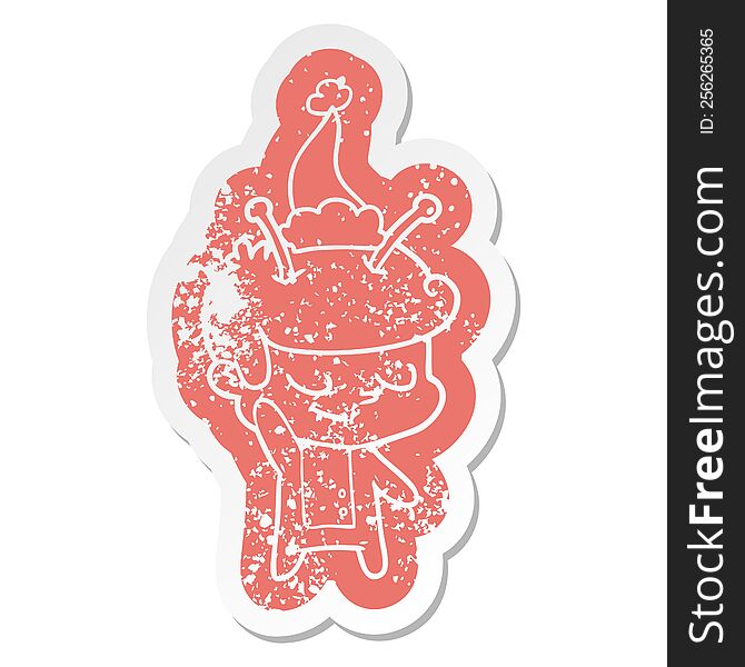 Friendly Cartoon Distressed Sticker Of A Spaceman Wearing Santa Hat