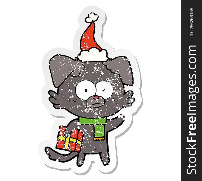 nervous dog hand drawn distressed sticker cartoon of a with gift wearing santa hat