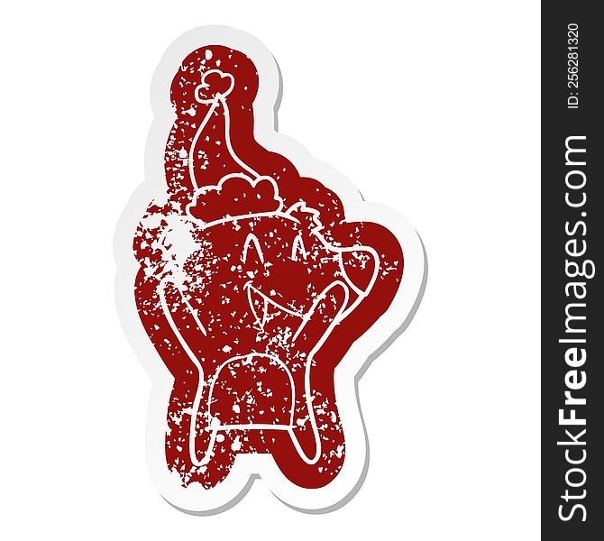 laughing polar bear quirky cartoon distressed sticker of a wearing santa hat