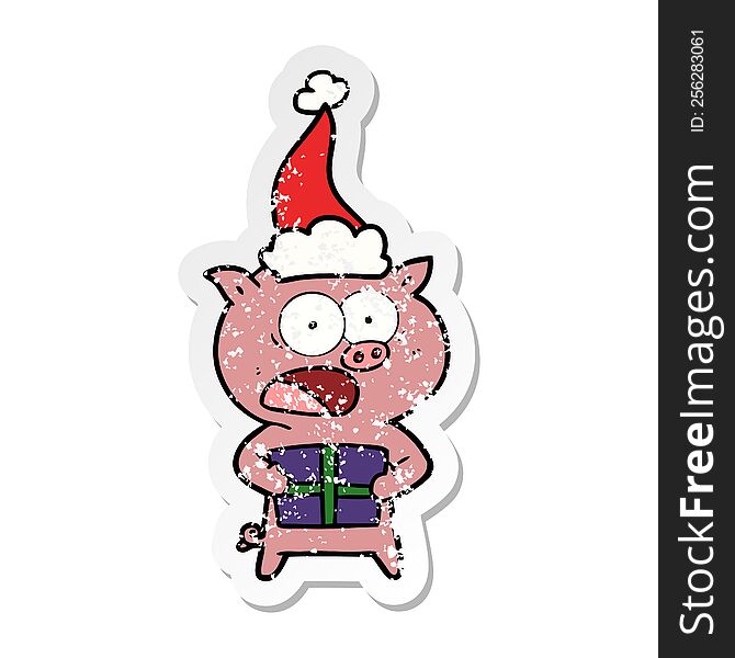 hand drawn distressed sticker cartoon of a pig with christmas present wearing santa hat