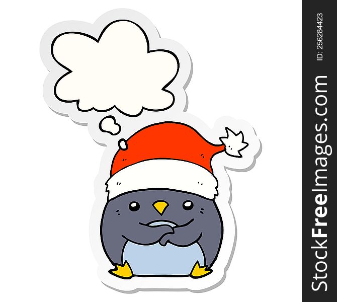 cute cartoon penguin wearing christmas hat and thought bubble as a printed sticker