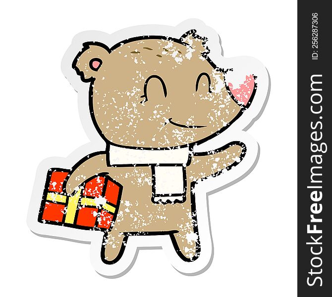 distressed sticker of a friendly bear with xmas gift and scarf