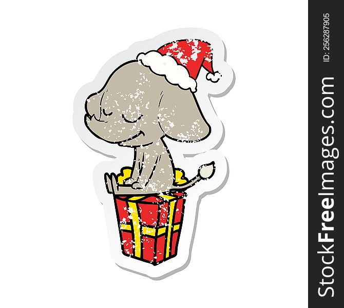 hand drawn distressed sticker cartoon of a smiling elephant wearing santa hat