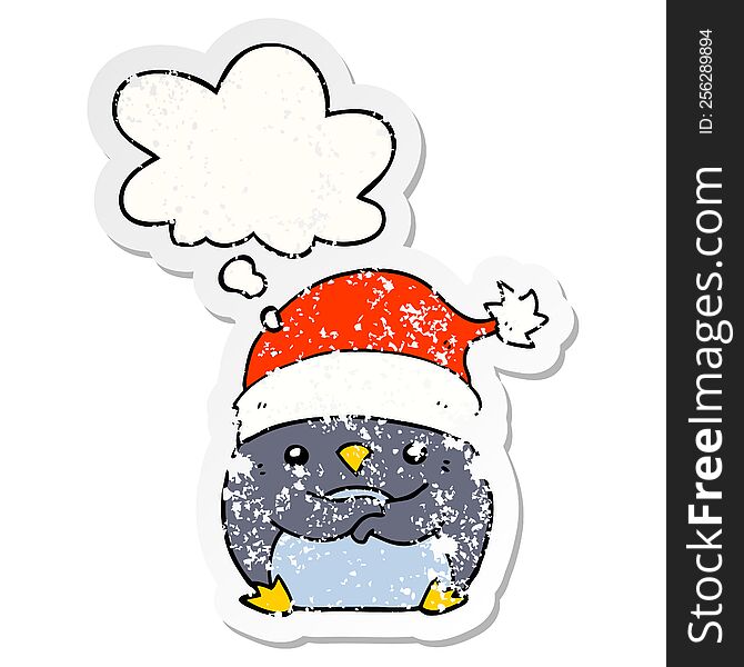 Cute Cartoon Penguin Wearing Christmas Hat And Thought Bubble As A Distressed Worn Sticker