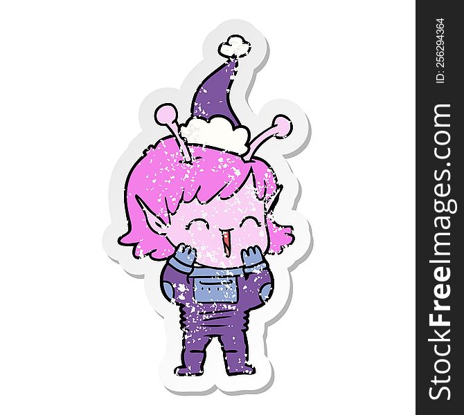 hand drawn distressed sticker cartoon of a alien girl giggling wearing santa hat