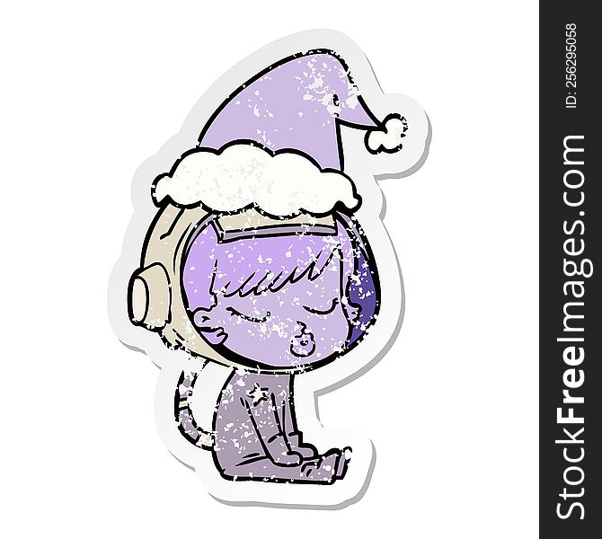 hand drawn distressed sticker cartoon of a pretty astronaut girl sitting waiting wearing santa hat