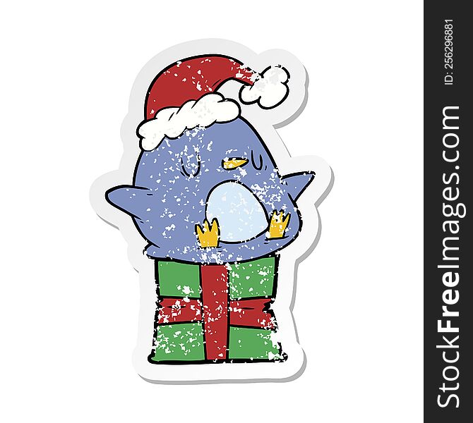 distressed sticker of a cute cartoon penguin sitting on gift