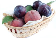 Ripe Peaches And Plums In The Basket Royalty Free Stock Photos