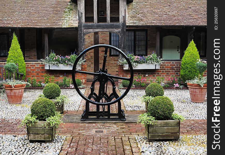 Medieval Cobbled English Courtyard Garden with Well in the center