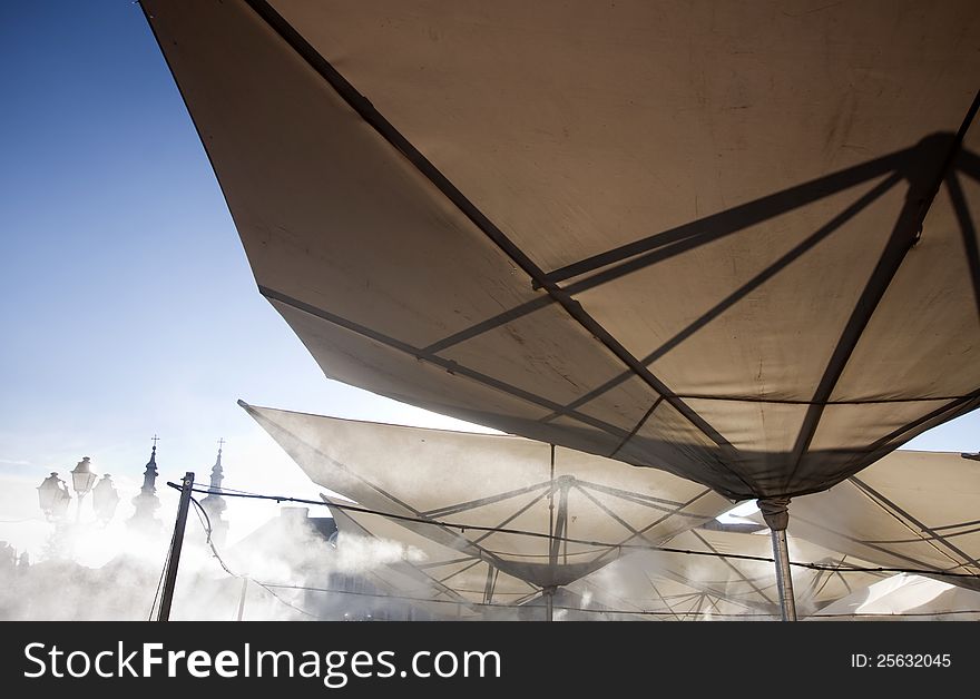 Abstract terrace umbrellas in city and blue sky