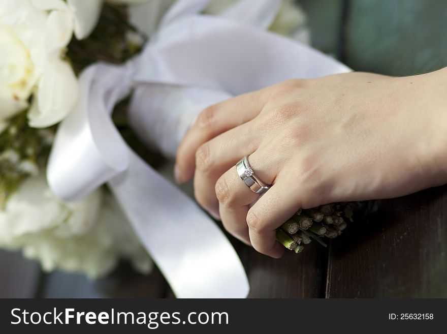 Bride holding white wedding bouquet