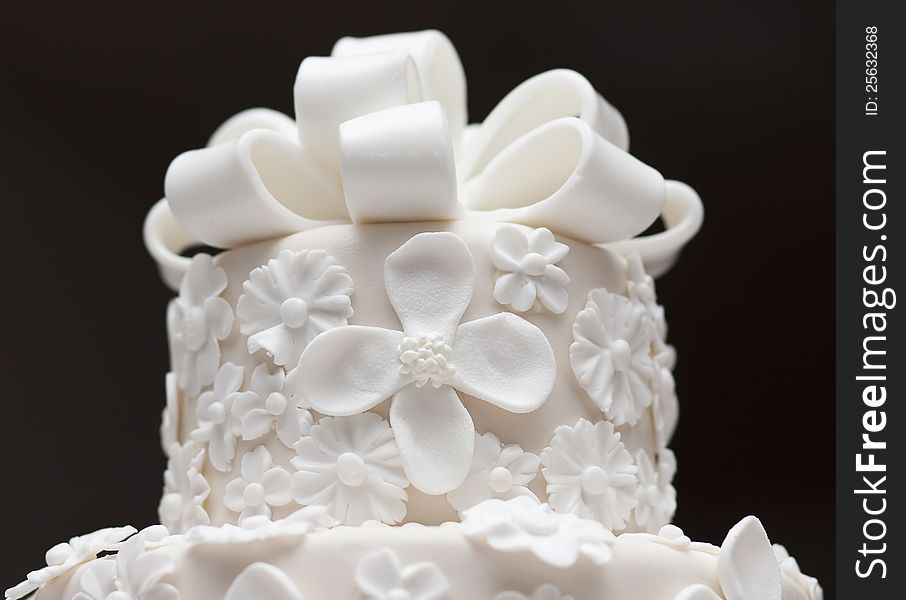 A white wedding cake isolated on dark