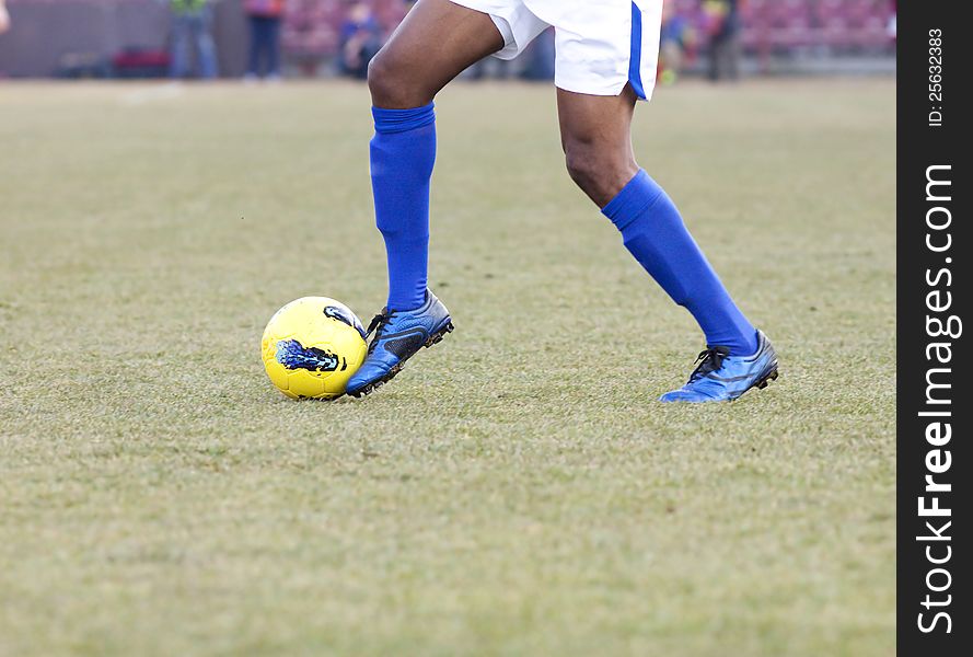 Soccer player running after the ball