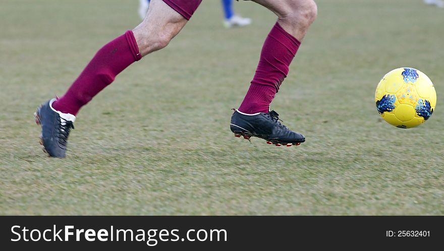 Soccer player running after the ball