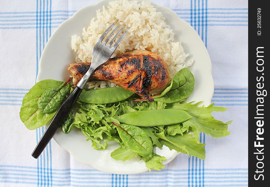 Grilled chicken leg with vegetables and rice