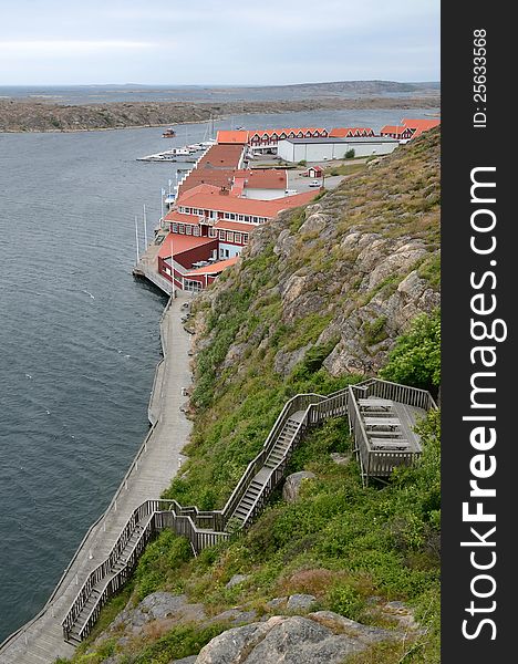 Vertical fjord landscape with generic architecture in cloudy day. Vertical fjord landscape with generic architecture in cloudy day