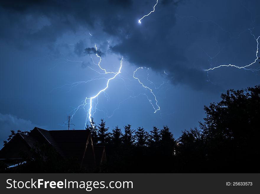 Another lightning during the night storm over a village. Another lightning during the night storm over a village