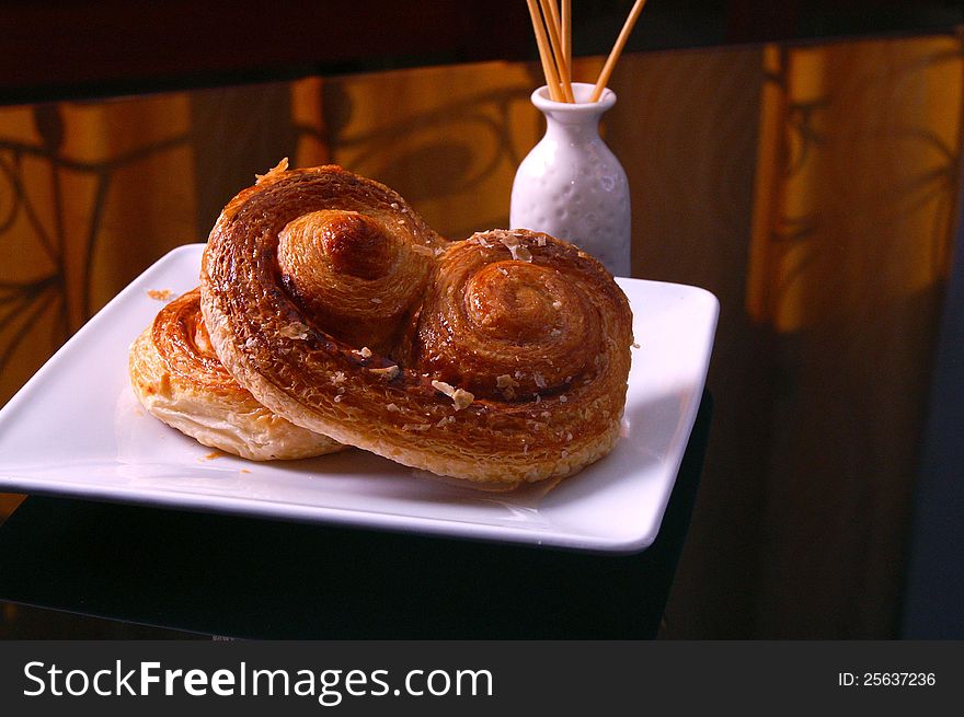 A dramatic shot of tasty Danish pastry in low-key mode.