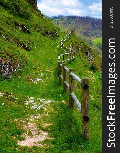 Mountain footpath protected by wooden fence. Mountain footpath protected by wooden fence