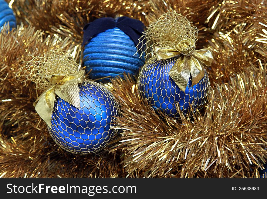 Blue christmas balls on a golden tinsel. Blue christmas balls on a golden tinsel