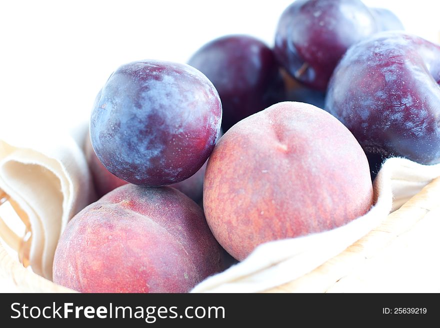 Peaches and blue plums in close-up. Peaches and blue plums in close-up