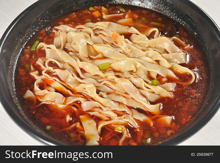 China Sichuan style noodles with pepper and minced meat. China Sichuan style noodles with pepper and minced meat