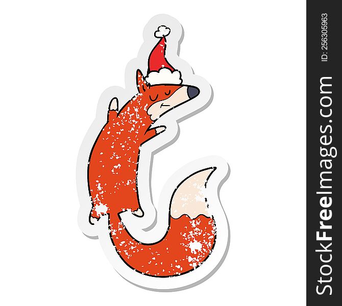hand drawn distressed sticker cartoon of a jumping fox wearing santa hat