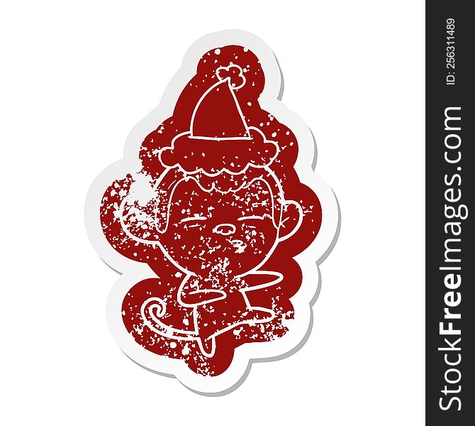 Cartoon Distressed Sticker Of A Suspicious Monkey Wearing Santa Hat