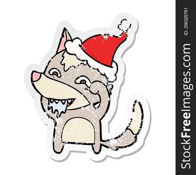 distressed sticker cartoon of a hungry wolf wearing santa hat