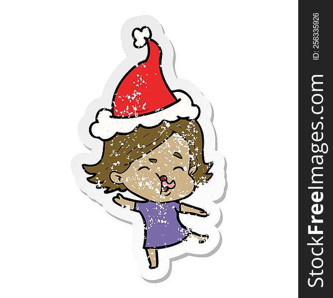 hand drawn distressed sticker cartoon of a girl pulling face wearing santa hat