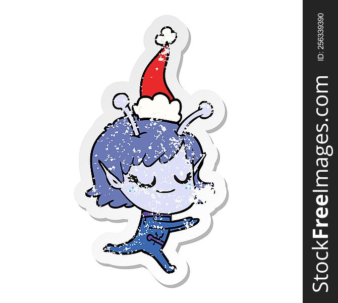 Smiling Alien Girl Distressed Sticker Cartoon Of A Running Wearing Santa Hat