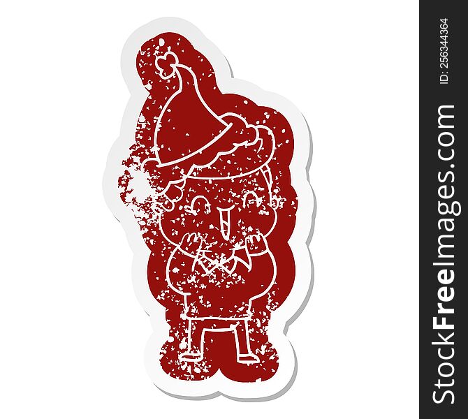 quirky cartoon distressed sticker of a laughing boy wearing santa hat