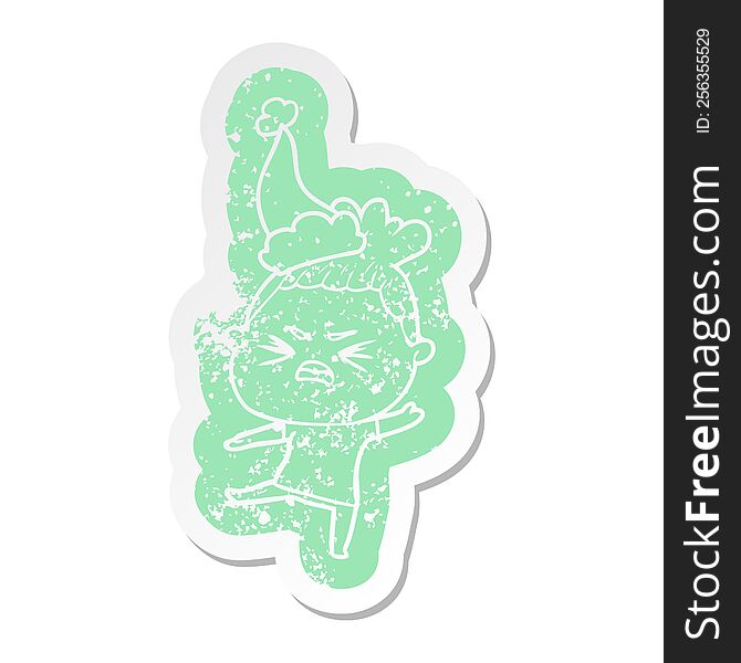 Cartoon Distressed Sticker Of A Angry Woman Wearing Santa Hat