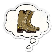 Cartoon Cowboy Boots And Thought Bubble As A Distressed Worn Sticker Royalty Free Stock Photo